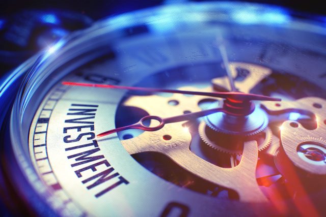 a close up of a watch face with a red second hand.